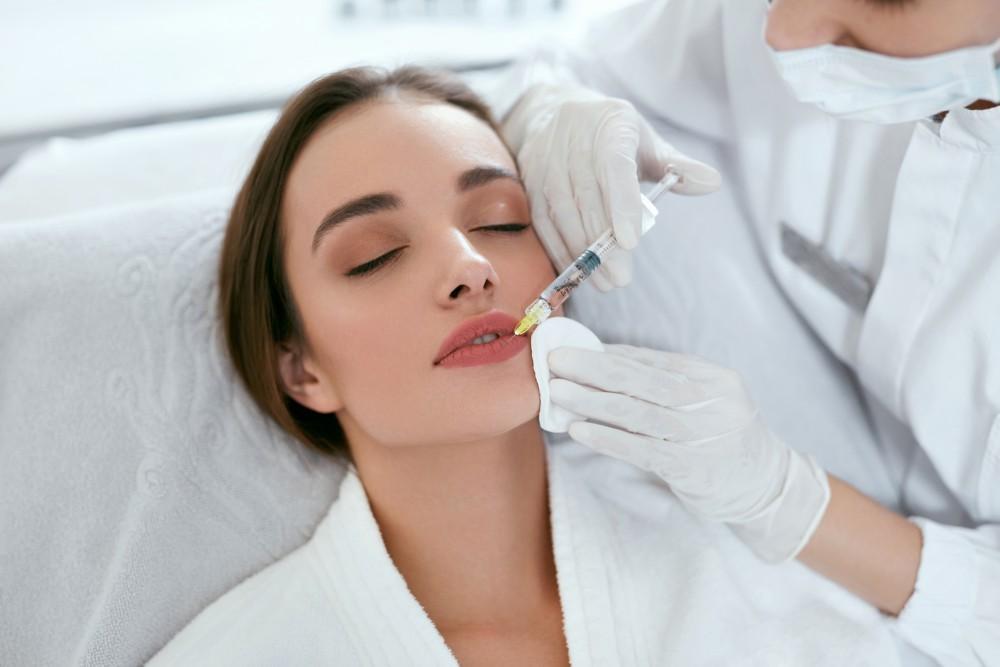 Woman getting face lifting injection on her lips | White Coat Aesthetics in Las Vegas, NV