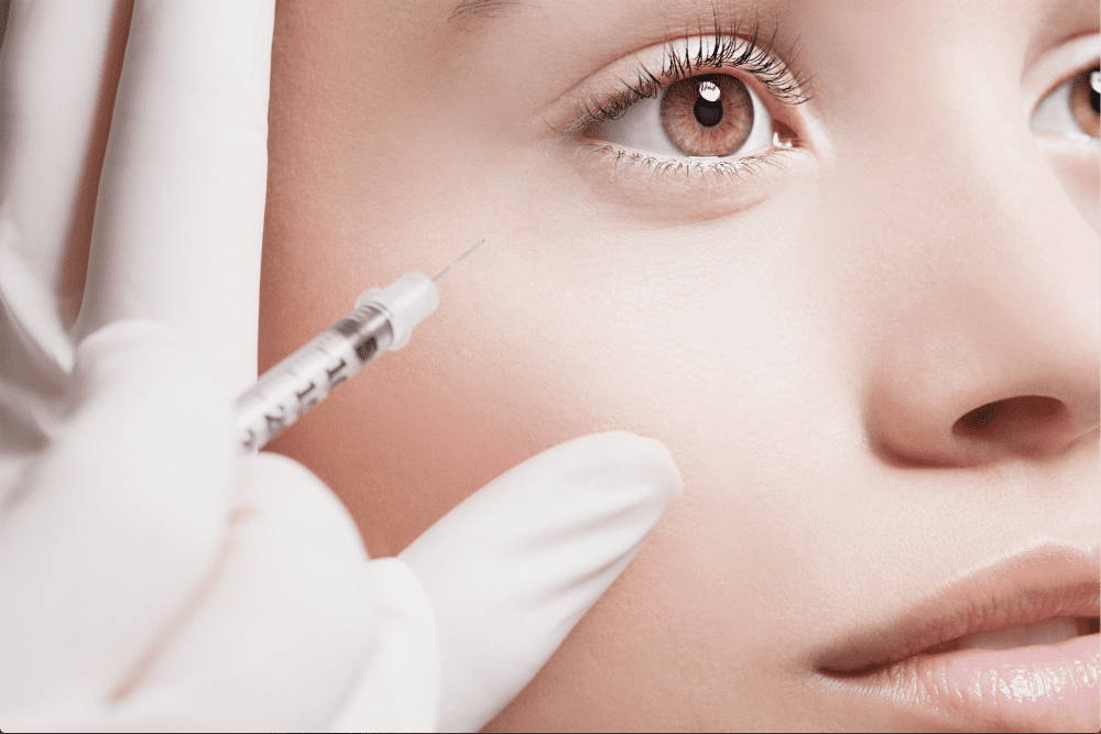 Woman getting face lifting injection on her face | White Coat Aesthetics in Las Vegas, NV