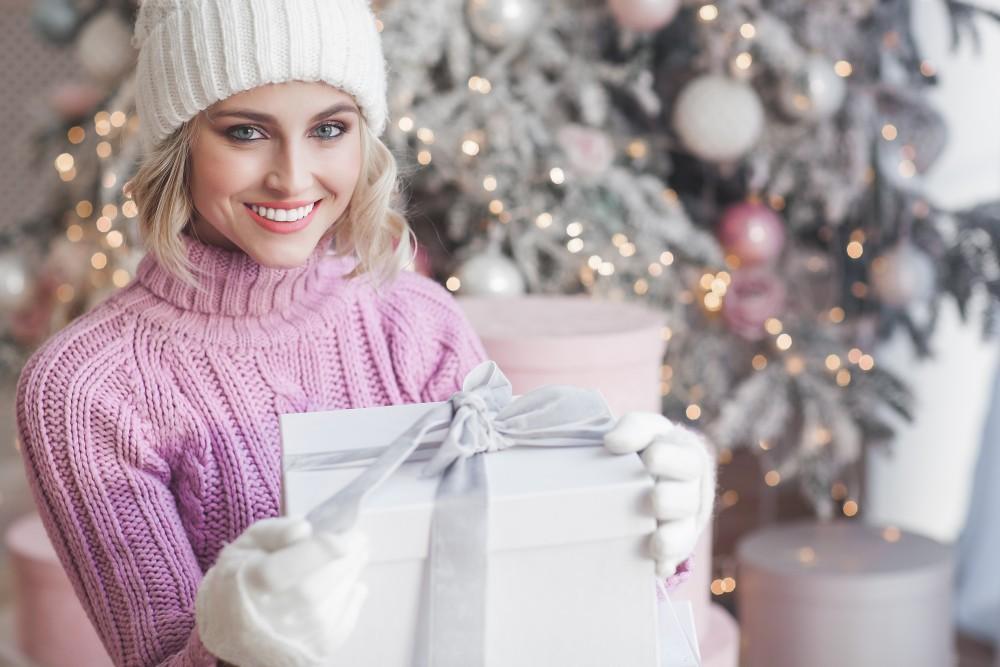 Beautiful blond woman on christmas background. Beauty near cristmas tree. Close up portrait of attractive female. | White Coat Aesthetics in Las Vegas, NV