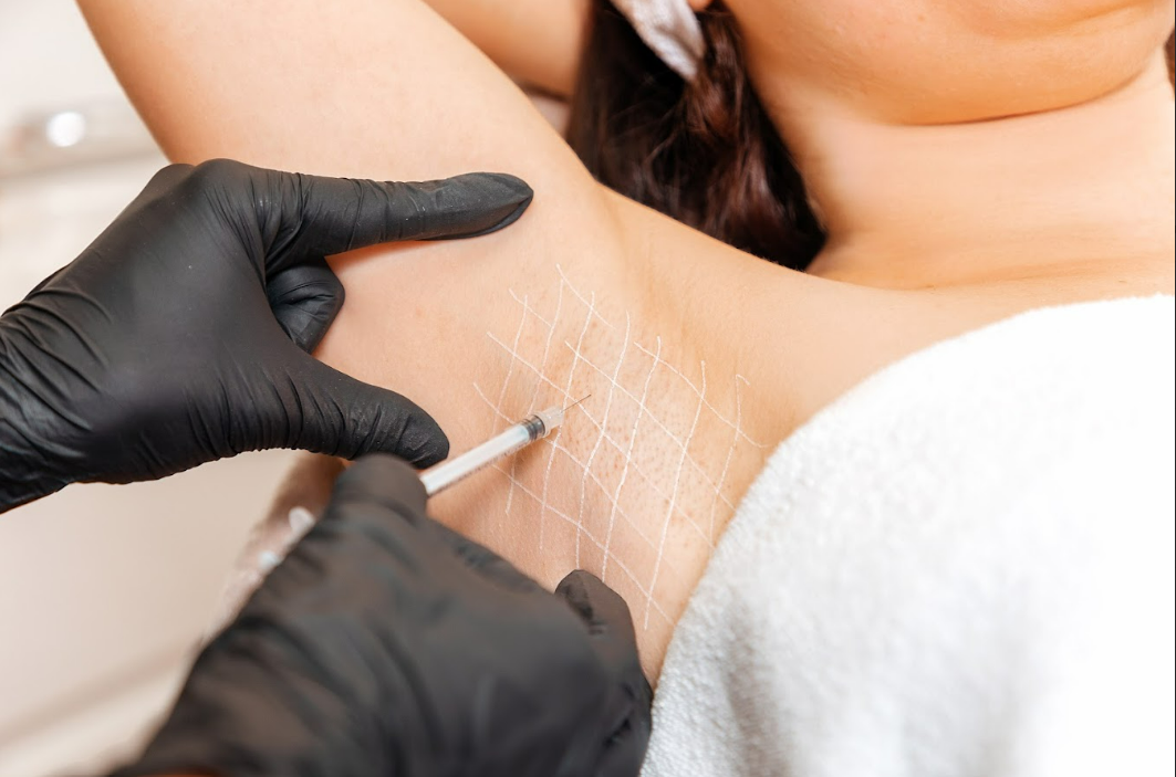Woman receiving injection on underarm area in Las Vegas, NV | White Coat Aesthetics