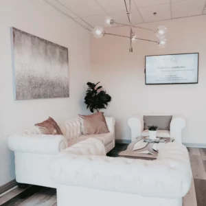White Coat Aesthetics waiting room with comforted couch
