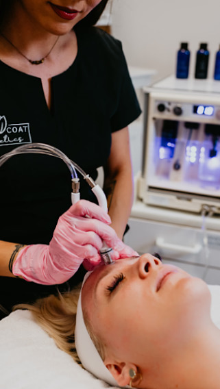 Young Beautician Performing DiamondGlow® Facial in Las Vegas, NV | White Coat Aesthetics